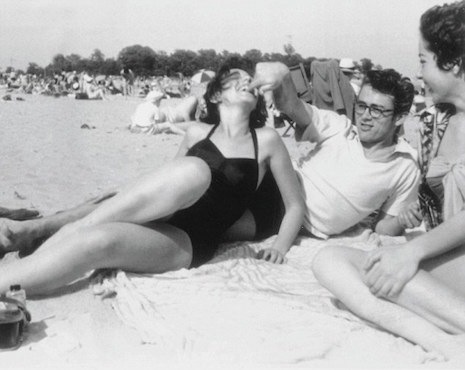 James Dean relaxing on the beach with his girlfriend Barbara Glenn