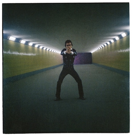 Striking a James Bond pose in a Berlin subway station, 1979. Taken with an old Rolleicord camera.