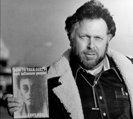 Al Goldstein holding a copy of Lenny Bruce's book,