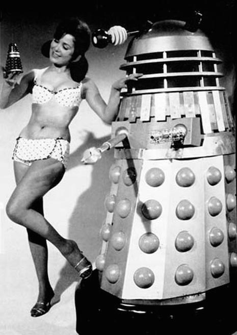 Bikini girls with a Dalek robot, 1950s
