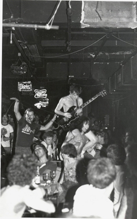 Bon Scott carrying Angus Young through the crowd at CBGB's, August 27th, 1977