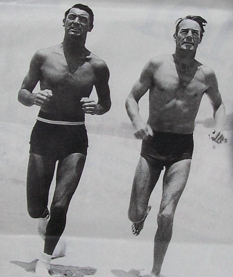 Cary Grant and Randolph Scott running on the beach, 1935