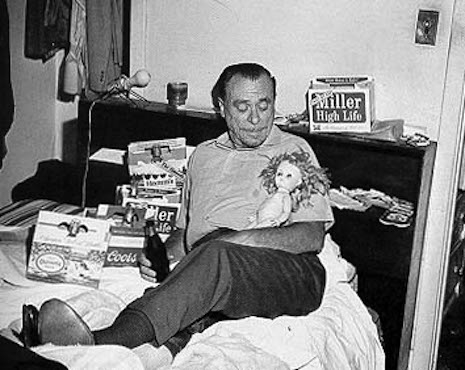 Charles Bukowski in his happy place, in bed drinking with a pretty doll