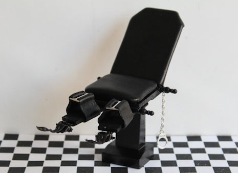 Miniature dollhouse bondage chair with handcuffs