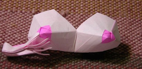 Origami boobs with curious hand