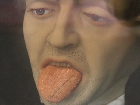 Wax face/head/bust of a man with stiches in his tongue