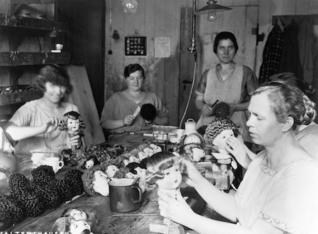 Doll factory workers styling doll hair, Germany 1931