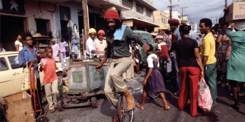 Peter Tosh rides a unicycle