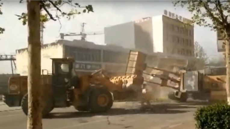 Watch six bulldozers battle it out in a batshit fight on the streets of China
