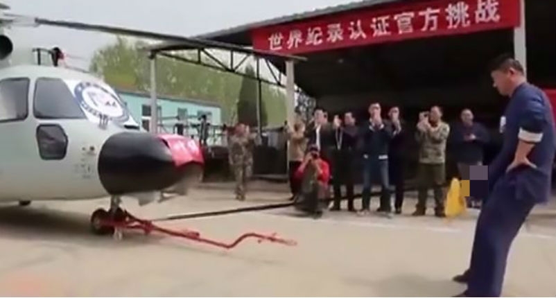 Watch a kung fu master pull an enormous helicopter attached to his penis
