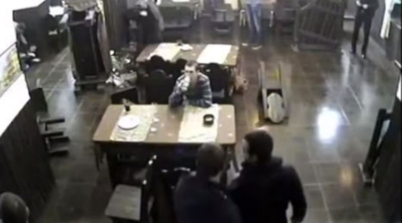 Unimpressed man calmly sits in restaurant while it’s invaded by masked gang