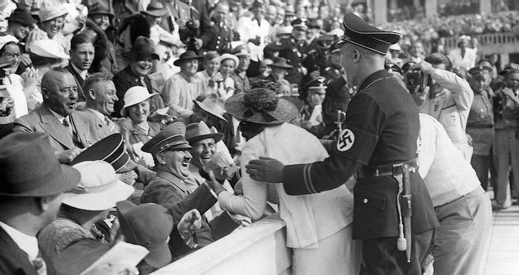 Hitler resists a kiss! Watch a bashful führer spurn the advances of an American fan at the Olympics!