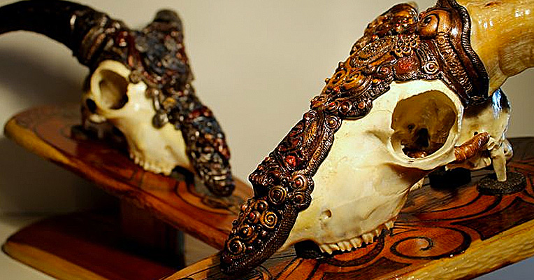 Ornately embellished wolf and goat skulls inspired by Norse myth