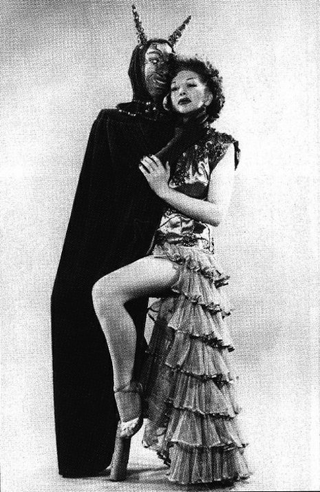 Burlesque performer with satan costume/cape