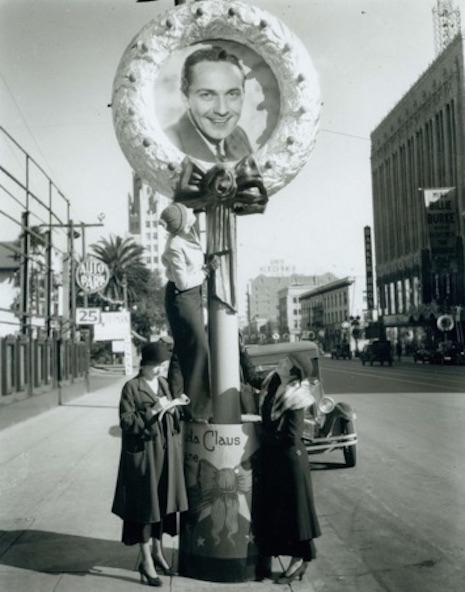 Women admiring actor Frederic March's wreath along the Santa Claus Lane Parade route on Hollywood Boulevard, 1932