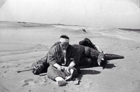 Harou Nakajima taking a smoke break on the beach with Godzilla