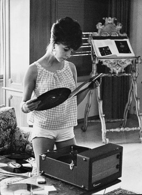 Joan Collins and her record player, 1960s