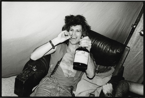 Keith Richards and his ever present bottle of brown liquor