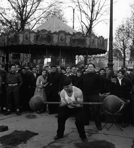 A strongman giving a demonstration at Les Banquises place de la Bastille, 1945