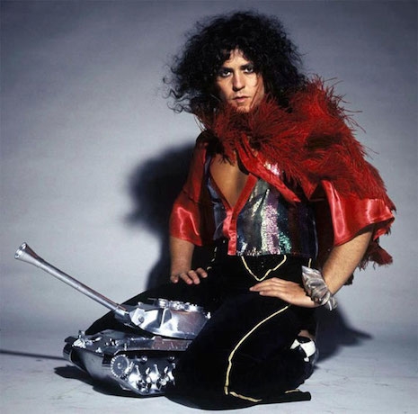 Marc Bolan riding a tiny shiny tank