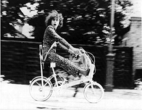 Marc Bolan riding on top of a bike