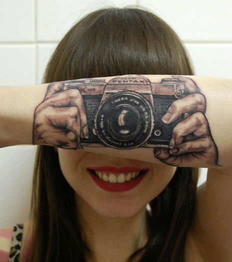 Arm tattoo looks like you're shooting a camera | Dangerous Minds