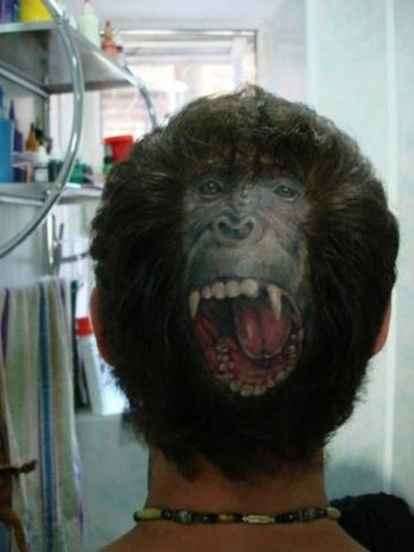 Bizarre monkey-face tattoo on the back of some guy’s head