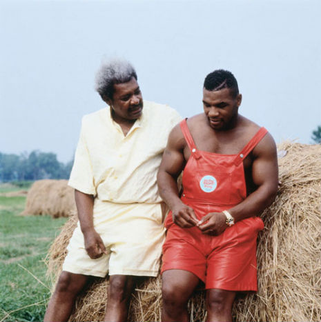 Amazing photo: Don King consoles Mike Tyson, in red leather overalls, sitting on a bale of hay